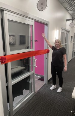 Emily Rozsonits cutting ribbon at ER Wellness shop opening event